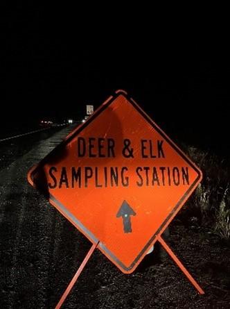 Road sign stating Deer and Elk Sampling Station