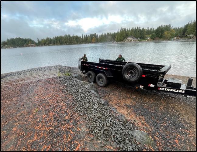 A trailer backed up to the boat ramp at Lost Lake after it dumped fresh gravel.  