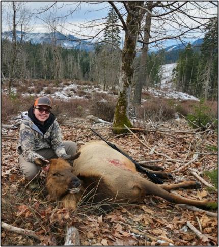 A youth hunter with an elk