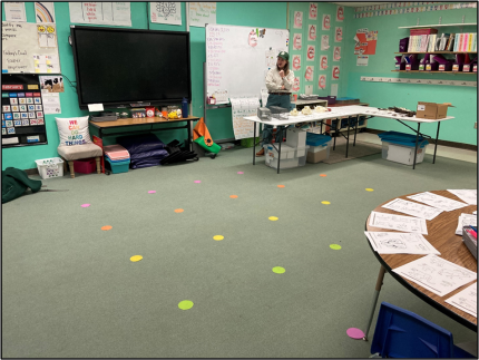 A classroom with colored dots on the floor