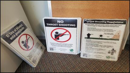 A stack of signs indicating no target shooting
