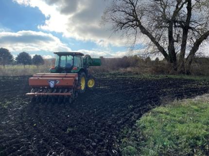 Drill and tractor seeding a small Conservation Reserve Enhancement Program project.