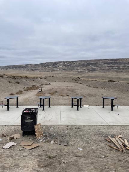 A shooting range with trash on the ground