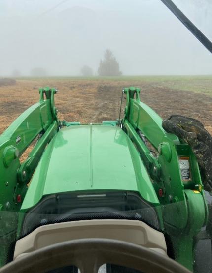 View from interior of tractor while mowing during one foggy morning.