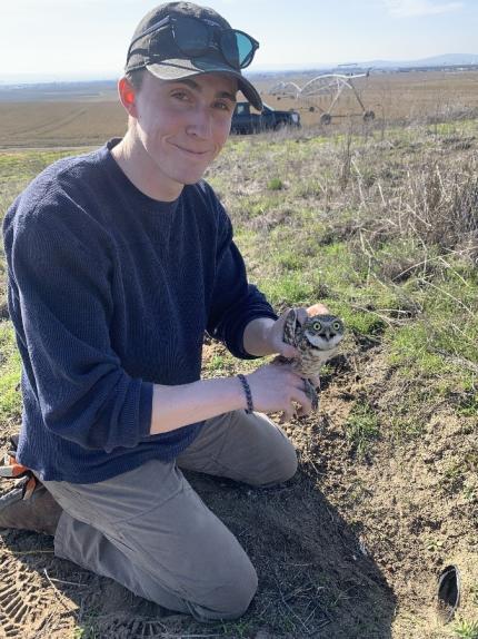 District 4 Assistant Biologist Hoffman with an adult burrowing owl.